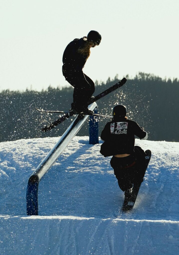 Freestyle skiers training in a terrain park, showcasing creative skiing and progression on snow features.