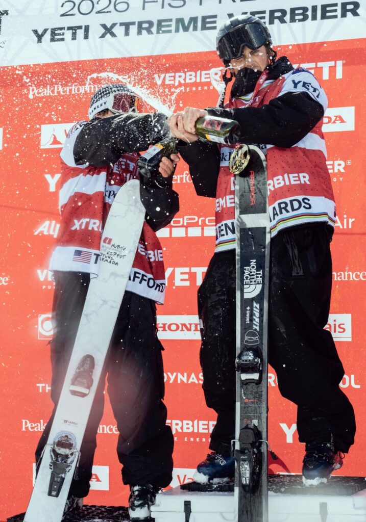 Armada-sponsored ski athletes celebrate on the Freeride World Tour podium in Verbier, spraying champagne after the competition.