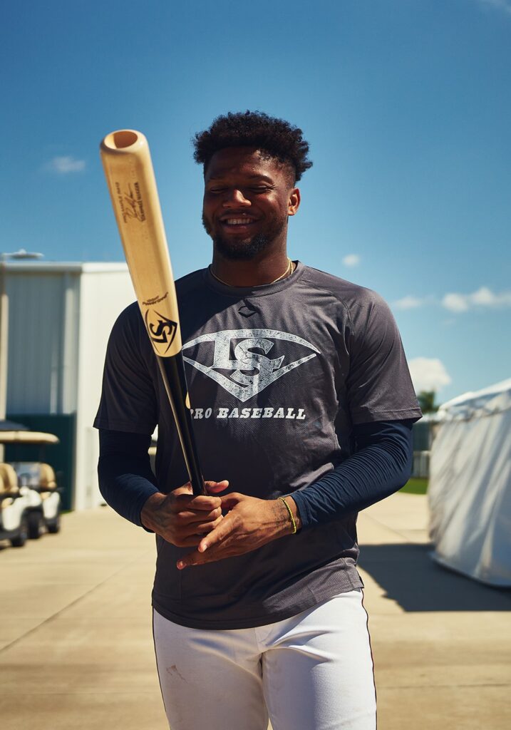 Ronald Acuna Jr. smiling with a Louisville Slugger bat in hand