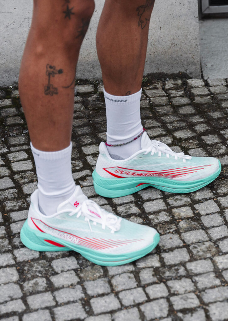 A person wearing Salomon Spectur shoes.