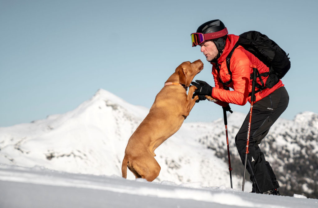 Herbi skitouring with his dog Bruno
