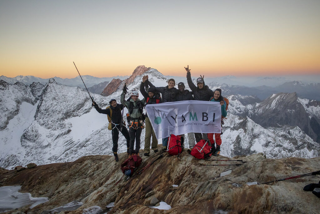Members of Yambi organization on top of a mountain peak.