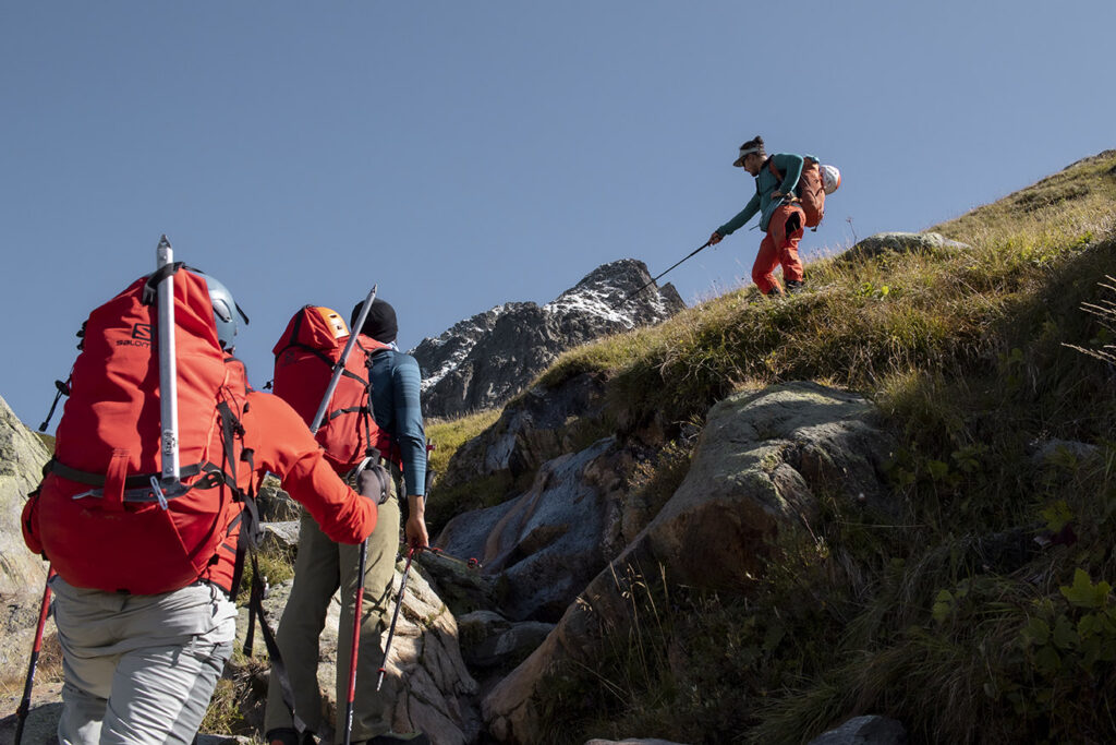 Members of Yambi organization trekking up a mountain.