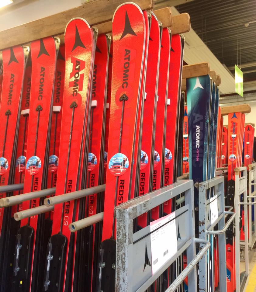 Atomic's red alpine skis in rolling cage.