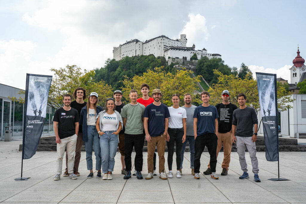 13 participants in Atomic's event posing in front of the castle.