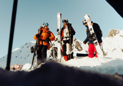 Group of Arc'teryx athletes on a snowy mountain ready to ski