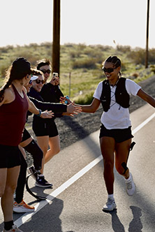 Tilly ocean running while high-fiving her teamates.