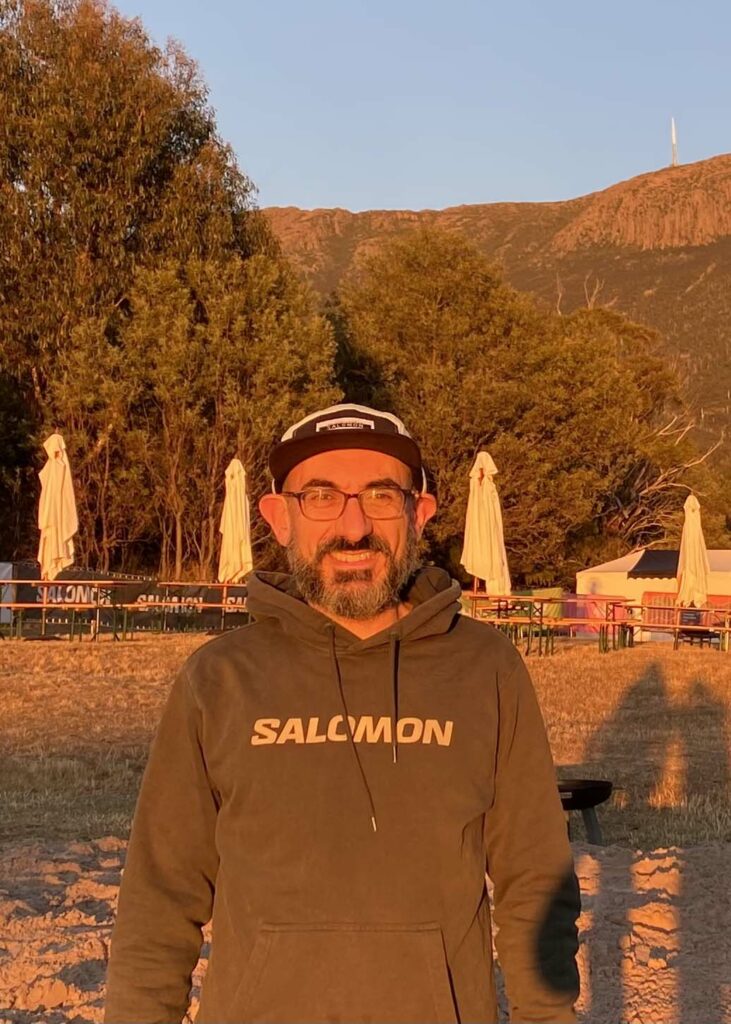 Damian Krokos in the outdoors with a Salomon hoodie.