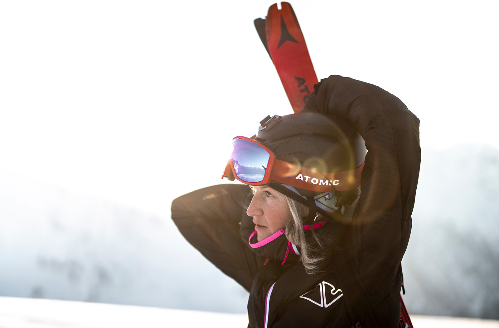 A person holding skis.