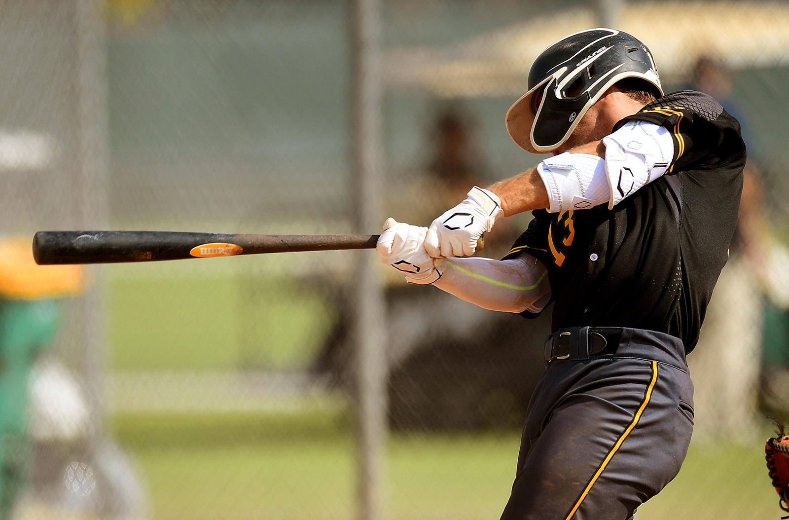 A baseball player hitting a baseball in a game.