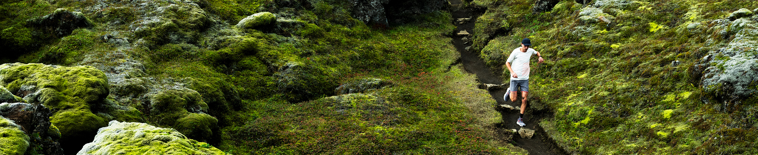A person running on a green hill.