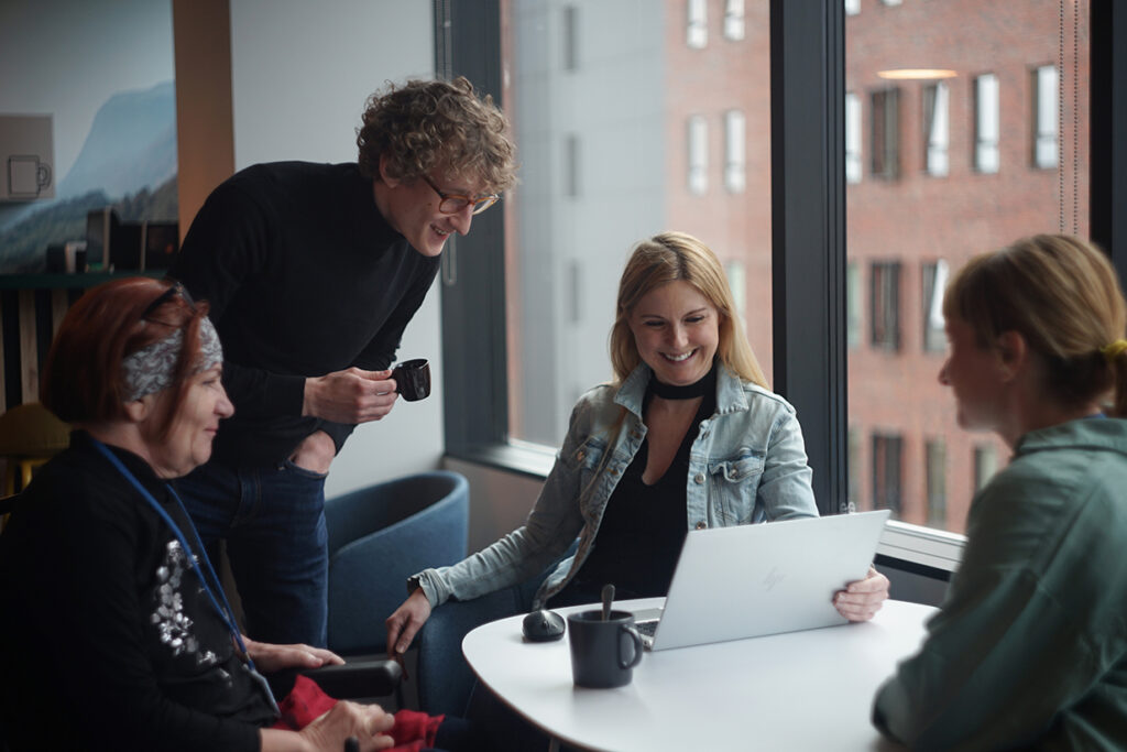 A group of employees smiling in an office