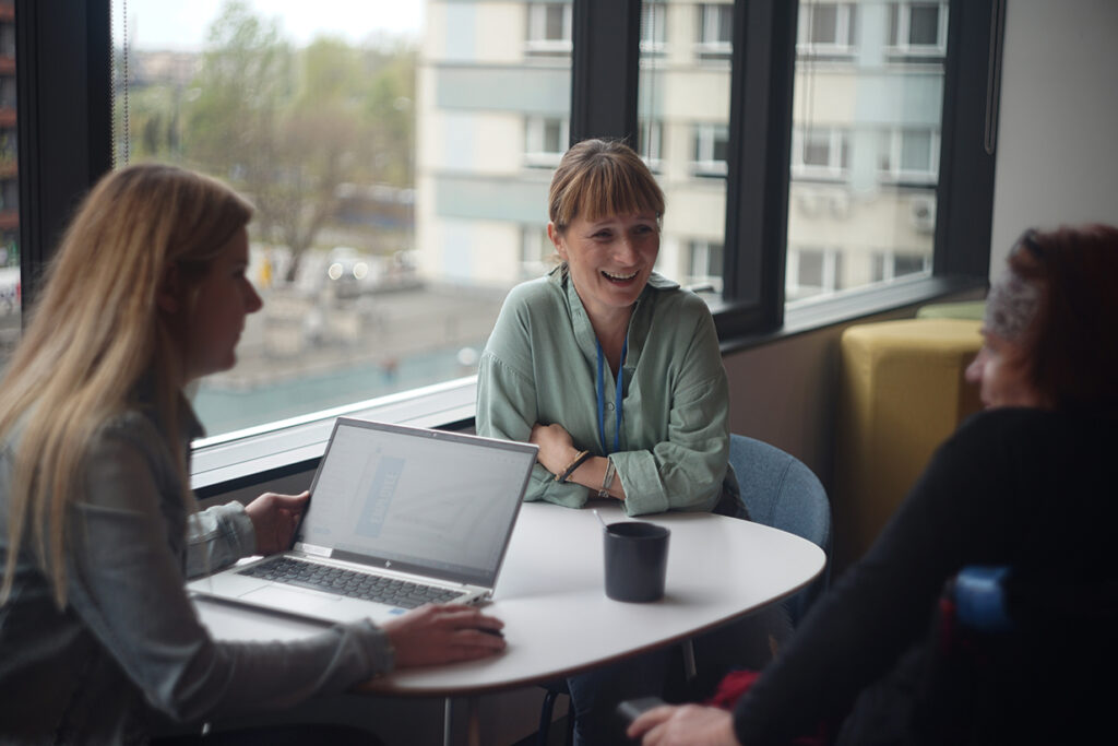 A group of people laughing in an office